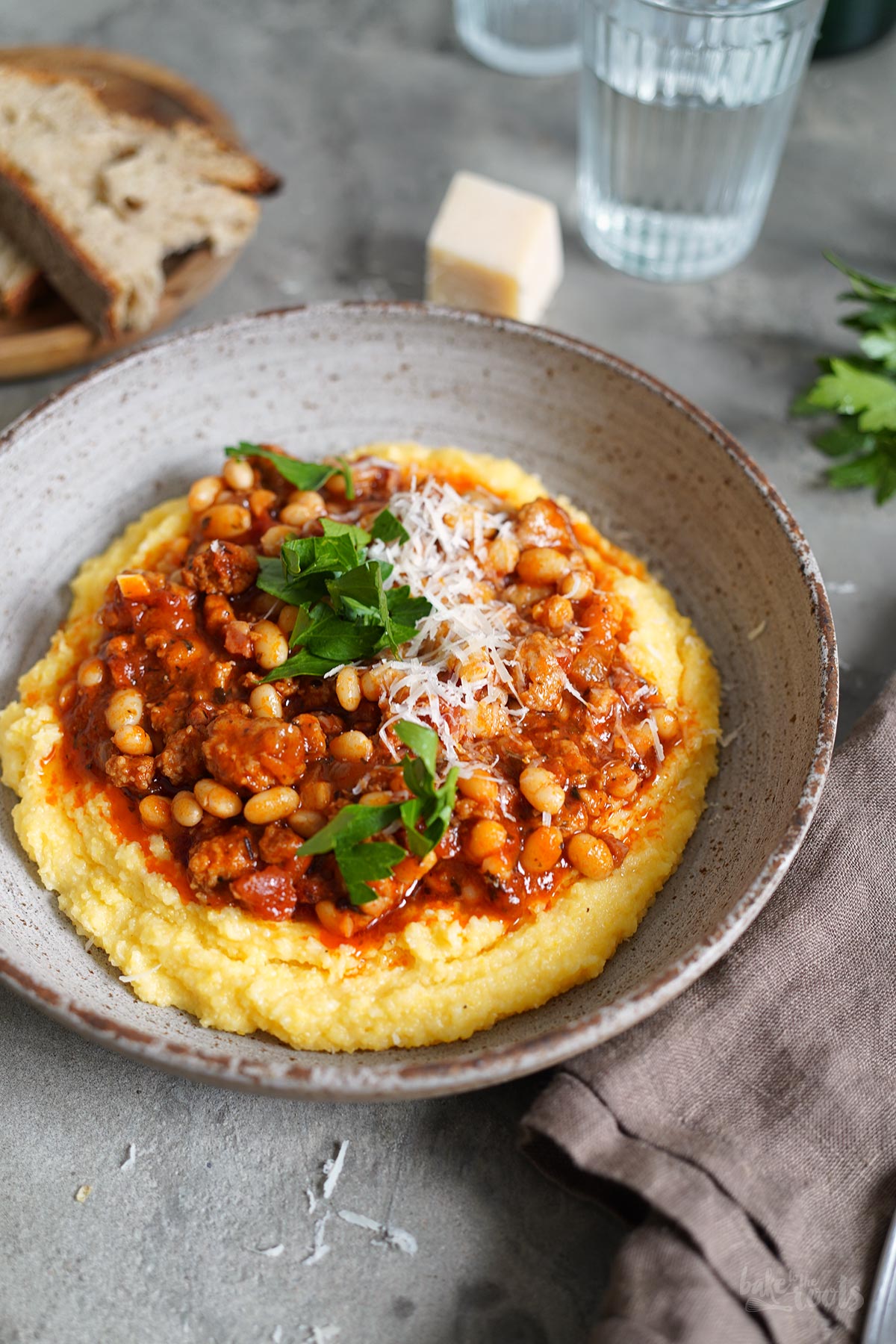 Sausage & Bacon Ragù with White Beans and Polenta Bake to the roots