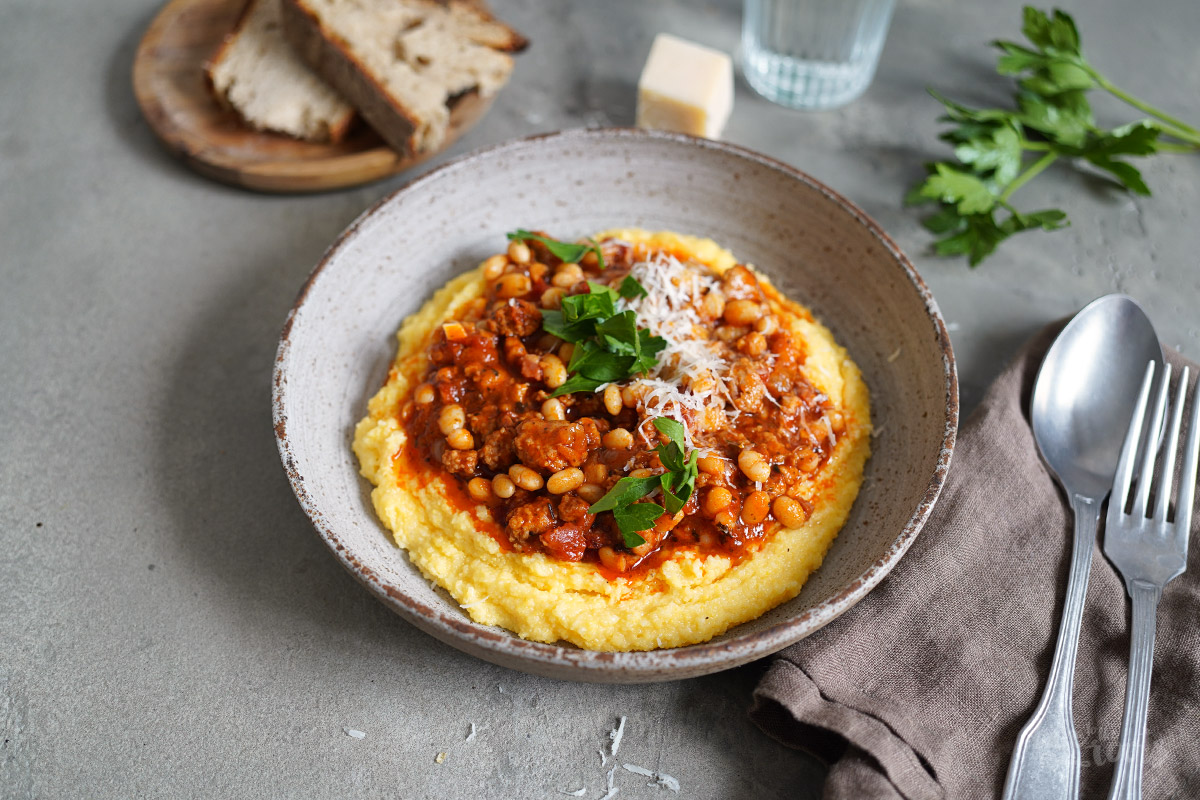 Sausage & Bacon Ragù with White Beans and Polenta Bake to the roots