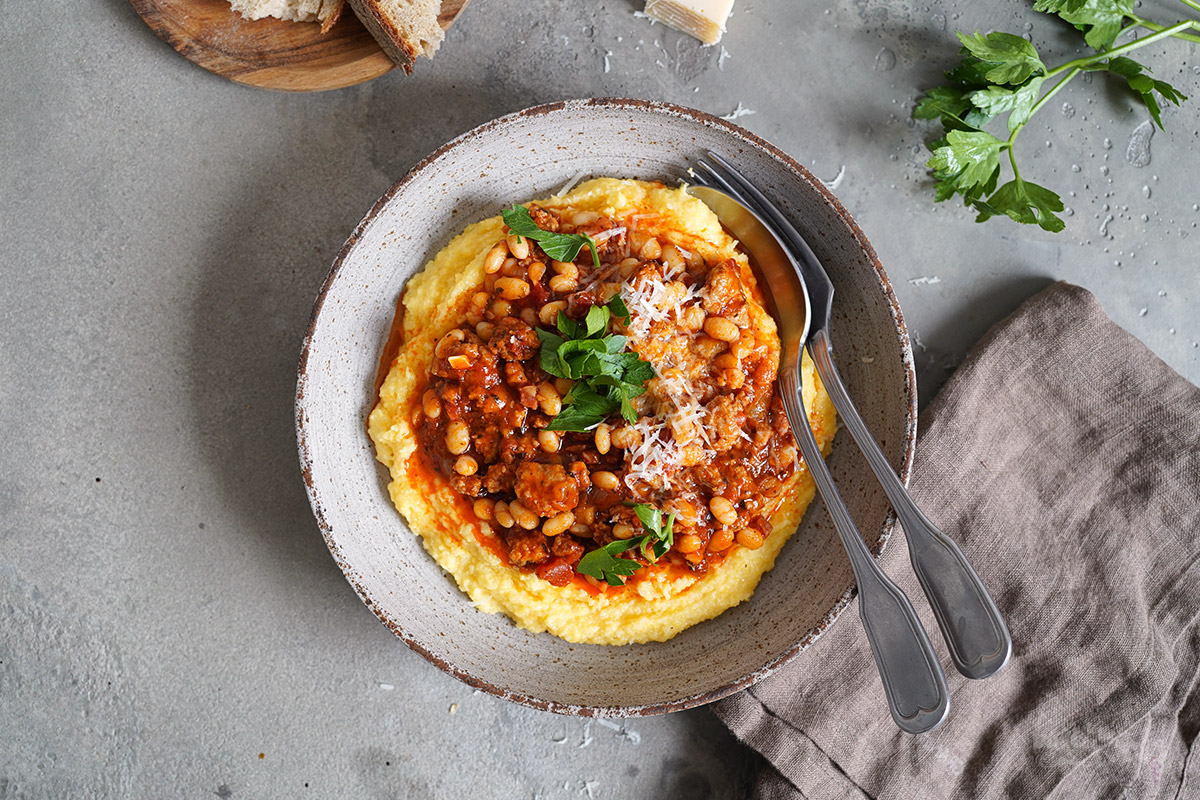 Sausage & Bacon Ragù with White Beans and Polenta | Bake to the roots